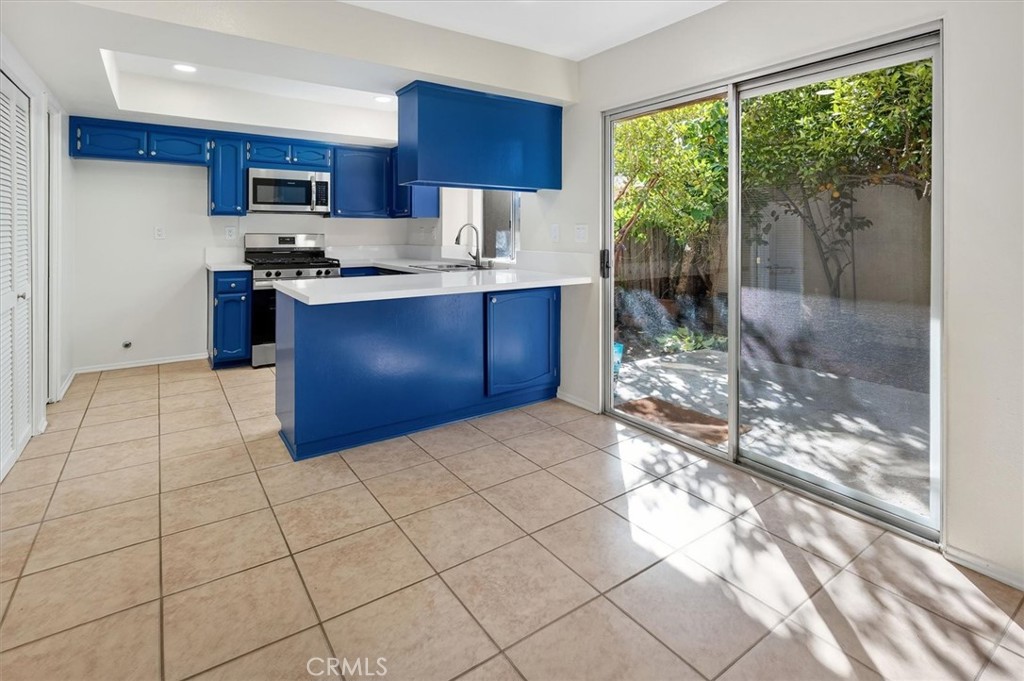 14344 Foothill Boulevard, Unit 1004 Sylmar, CA 91342 - Photo 8 of 27 a kitchen with stainless steel appliances granite countertop a stove a sink and a refrigerator