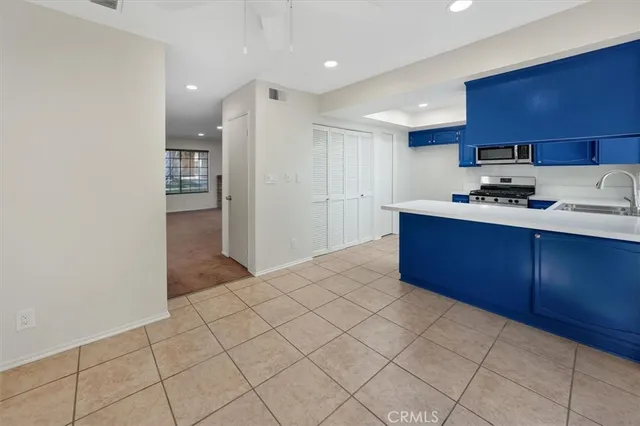 a kitchen with stainless steel appliances granite countertop a sink stove and cabinets