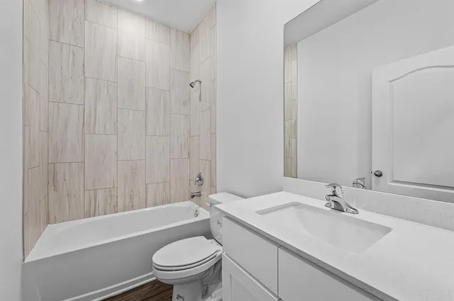 a bathroom with a sink a toilet and a bathtub