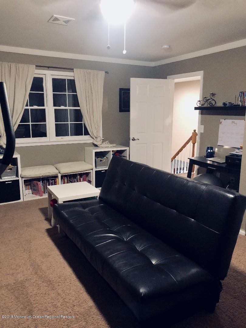 220 Schooner Road Manahawkin, NJ 08050 - Photo 12 of 25 a living room with furniture and a floor to ceiling window