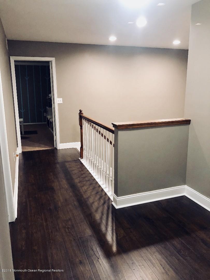 220 Schooner Road Manahawkin, NJ 08050 - Photo 13 of 25 a view of a hallway with wooden floor