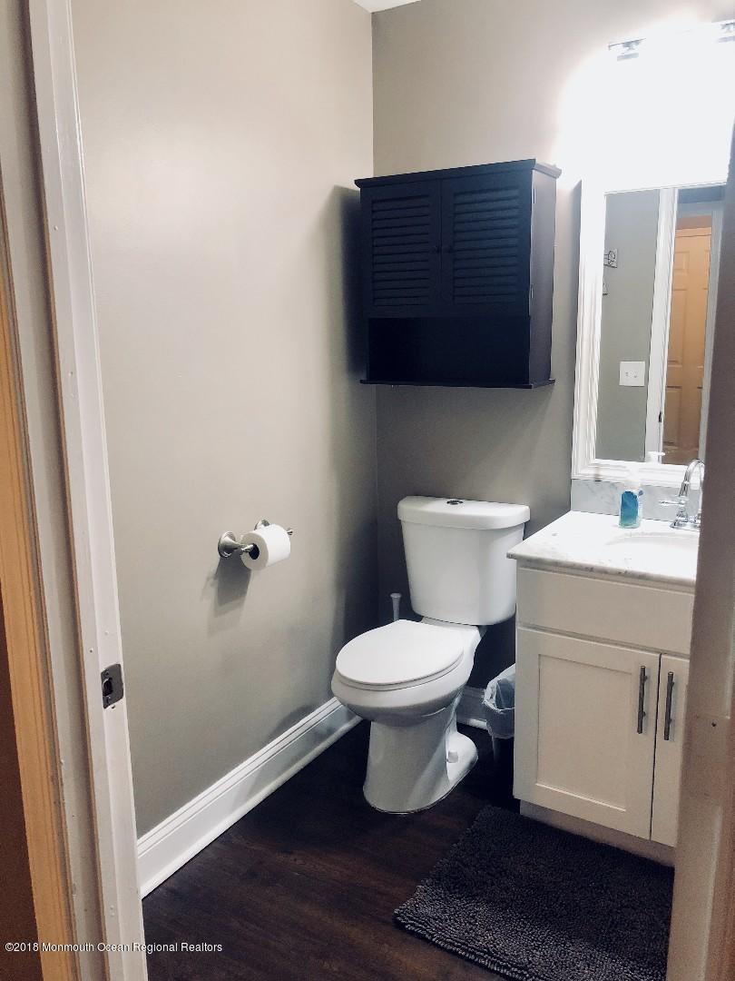 220 Schooner Road Manahawkin, NJ 08050 - Photo 15 of 25 a bathroom with a toilet sink and mirror