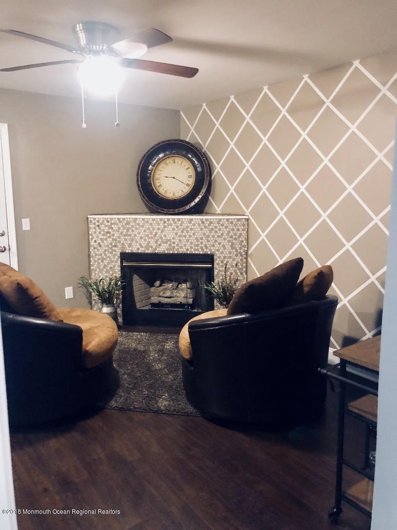 220 Schooner Road Manahawkin, NJ 08050 - Photo 17 of 25 a living room with furniture and a fireplace