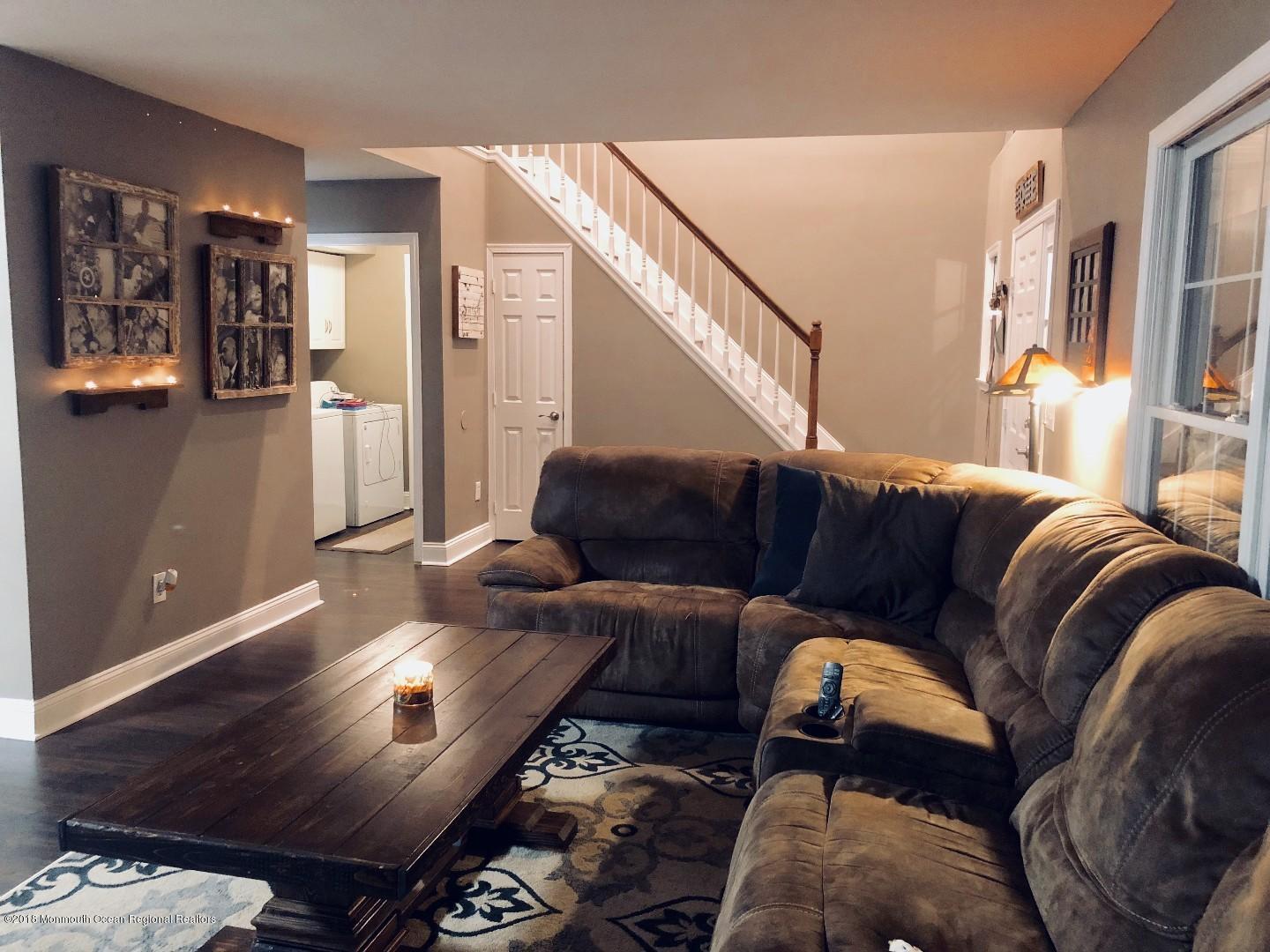 220 Schooner Road Manahawkin, NJ 08050 - Photo 21 of 25 a living room with furniture and a wooden floor