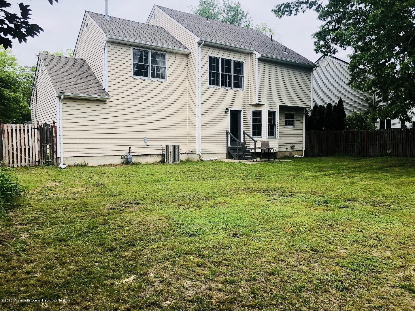 220 Schooner Road Manahawkin, NJ 08050 - Photo 25 of 25 a view of a house with a yard and sitting area