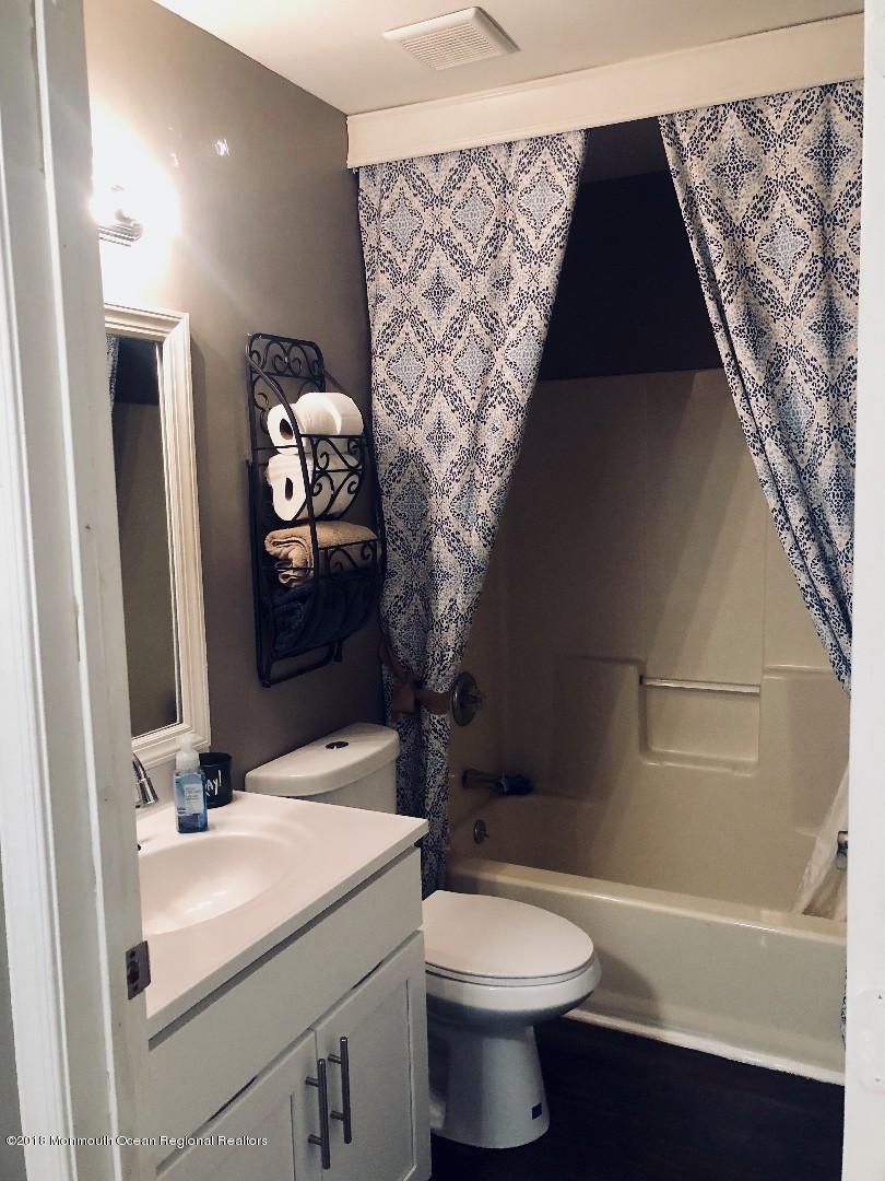 220 Schooner Road Manahawkin, NJ 08050 - Photo 4 of 25 a bathroom with a sink toilet and vanity