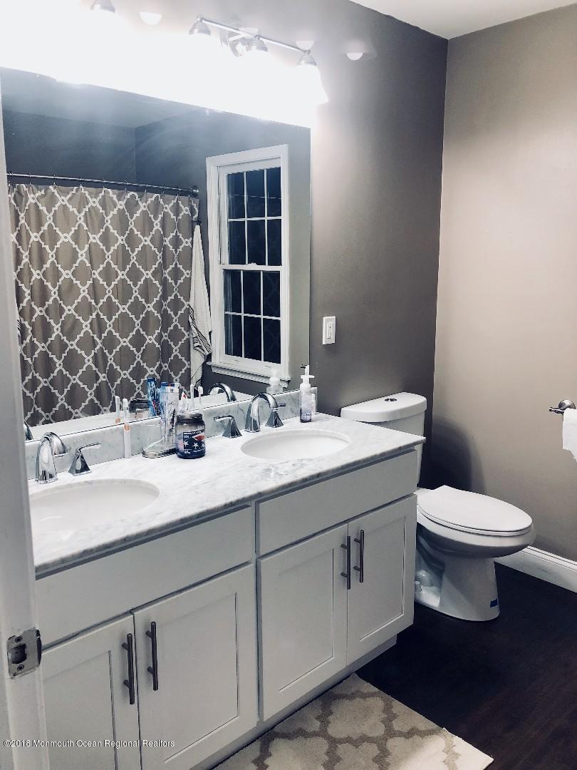 220 Schooner Road Manahawkin, NJ 08050 - Photo 8 of 25 a bathroom with a sink and a toilet