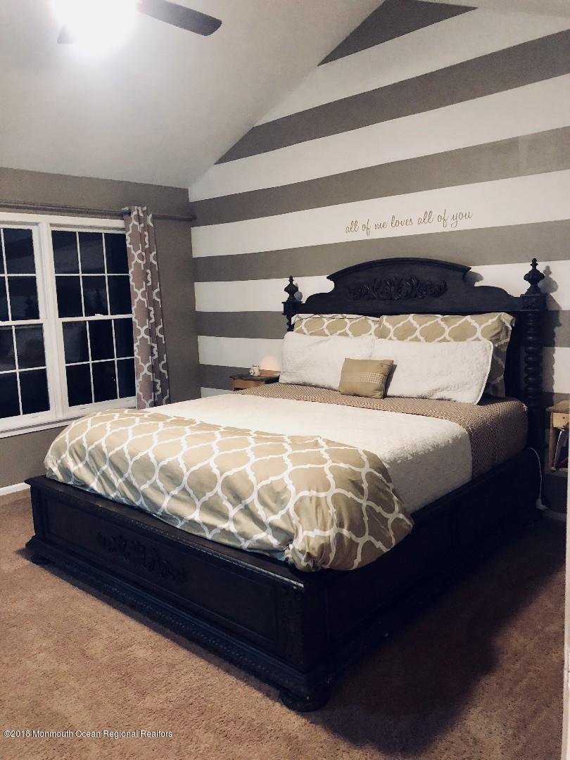 220 Schooner Road Manahawkin, NJ 08050 - Photo 10 of 25 a bedroom with a large bed and a window
