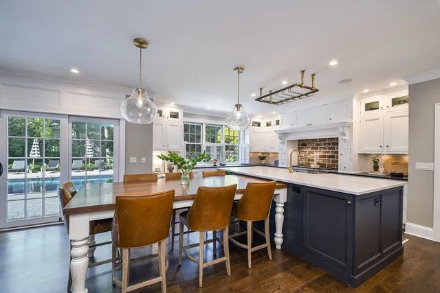 a kitchen with granite countertop white cabinets and window