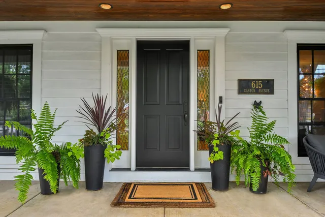 a kitchen with stainless steel appliances a dining table chairs refrigerator and sink