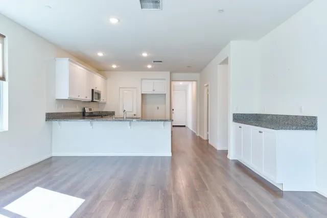 an empty room with windows and closet