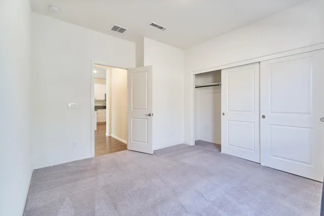 a kitchen with a refrigerator and a stove top oven