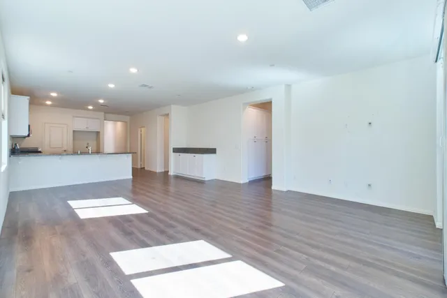 a kitchen with granite countertop white cabinets and stainless steel appliances