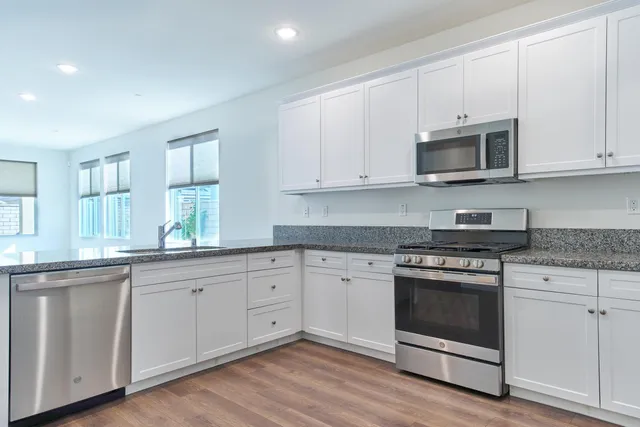 a room with granite countertop a sink and a window