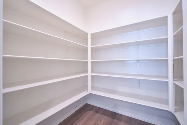 a view of a room with wooden floor and a window