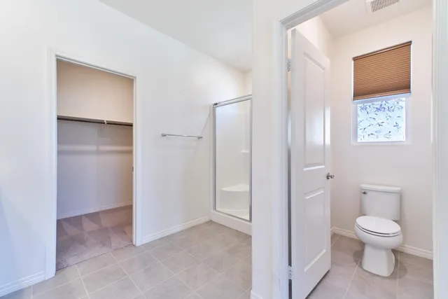 a bathroom with a glass shower door