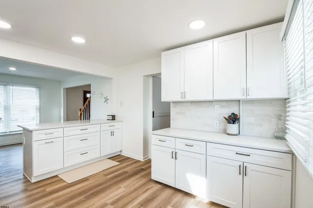 a kitchen with white cabinets and white appliances