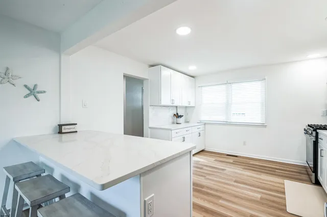 a kitchen with a table chairs and a refrigerator