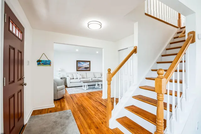 a living room with wooden floor and furniture