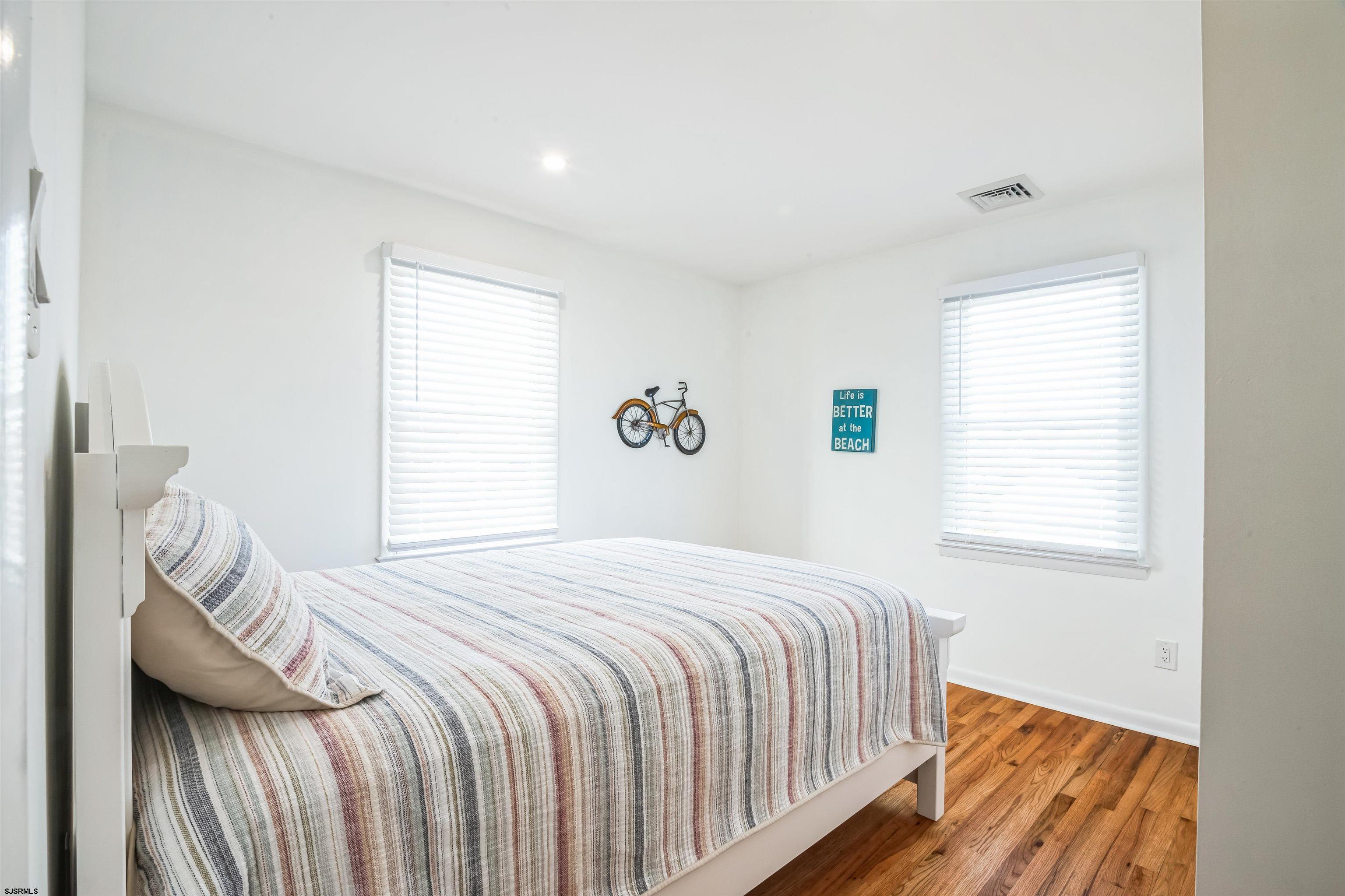 3304 Monmouth Avenue, Unit WINTER RENTAL Longport, NJ 08403 - Photo 18 of 29 a bedroom with a bed and a window