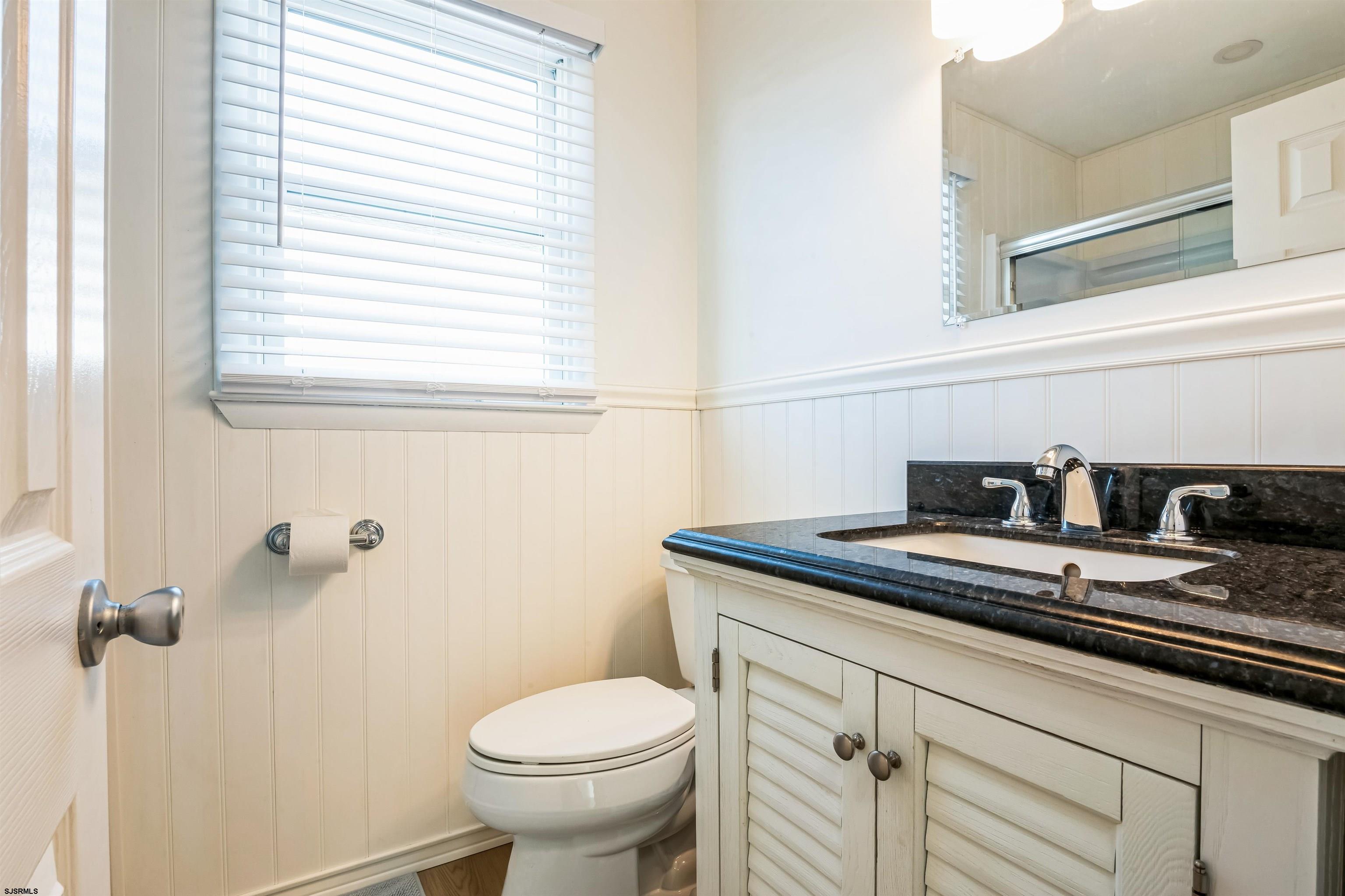 3304 Monmouth Avenue, Unit WINTER RENTAL Longport, NJ 08403 - Photo 19 of 29 a bathroom with a granite countertop sink toilet and a window