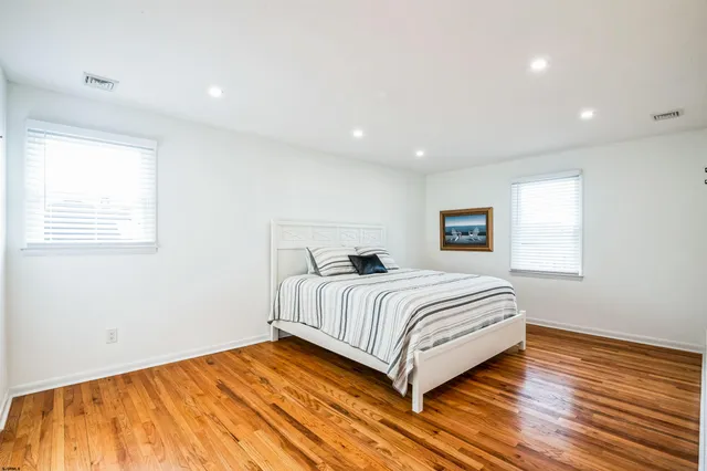 a bedroom with a bed and a night stand