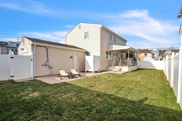 a backyard of a house with table and chairs