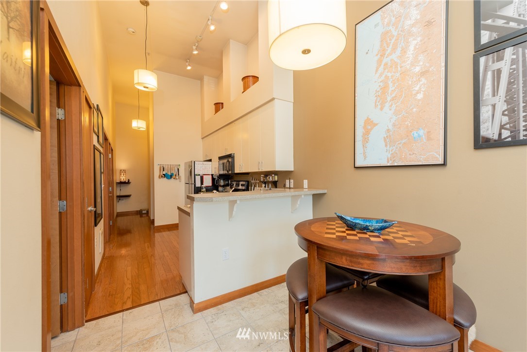 910 Gladstone Street, Unit 309 Bellingham, WA 98229 - Photo 6 of 25 a kitchen with stainless steel appliances a table and chairs