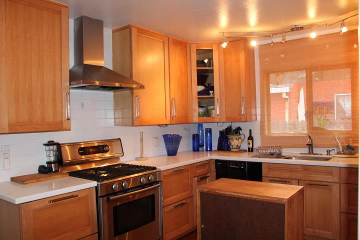 a kitchen with a sink stove and cabinets