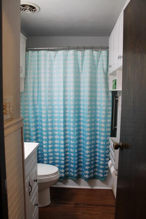 10433 Rockingham Drive Rancho Cordova, CA 95670 - Photo 14 of 34 a bathroom with a toilet and a shower curtain
