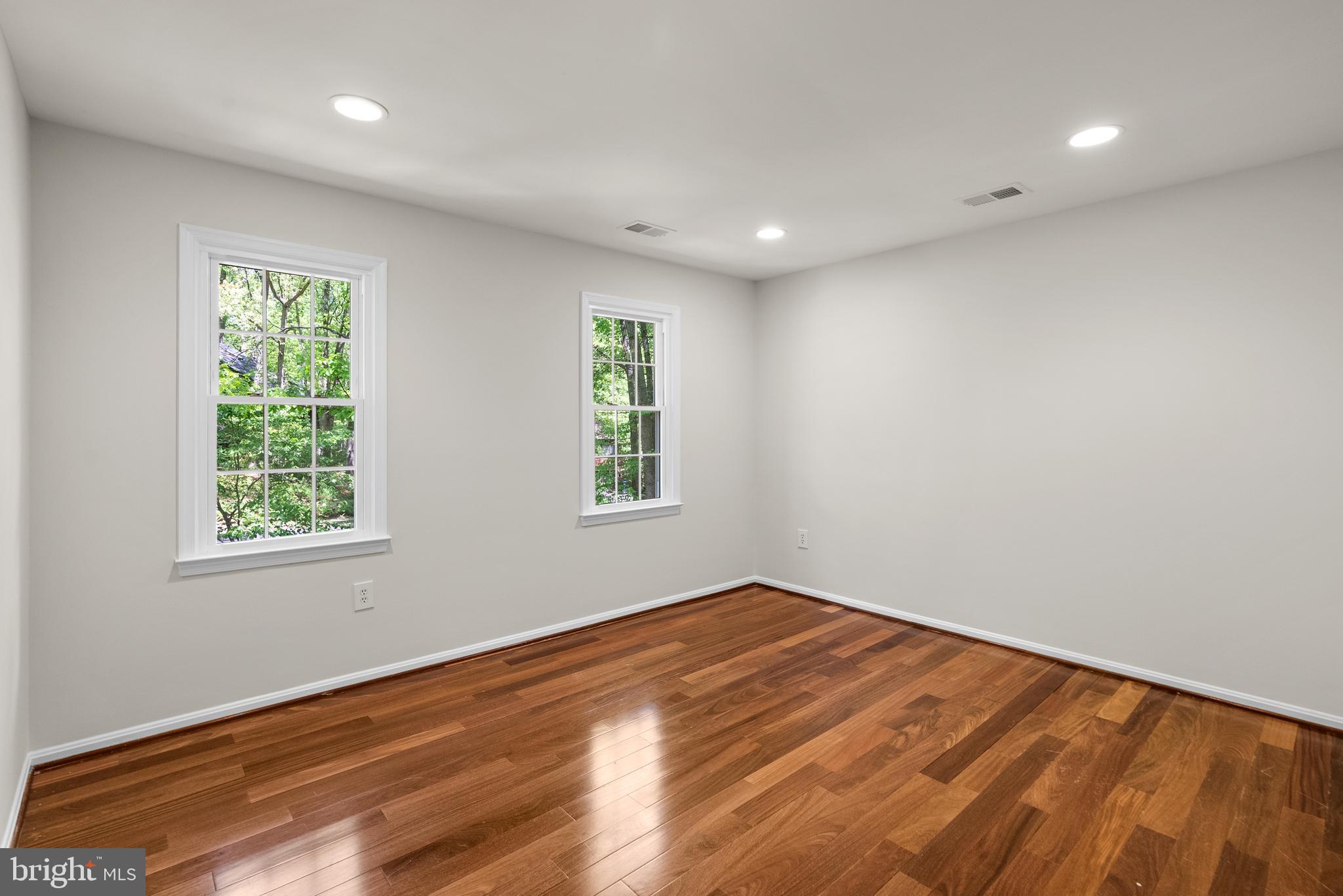 10717 Midsummer Drive Reston, VA 20191 - Photo 19 of 35 an empty room with wooden floor and windows