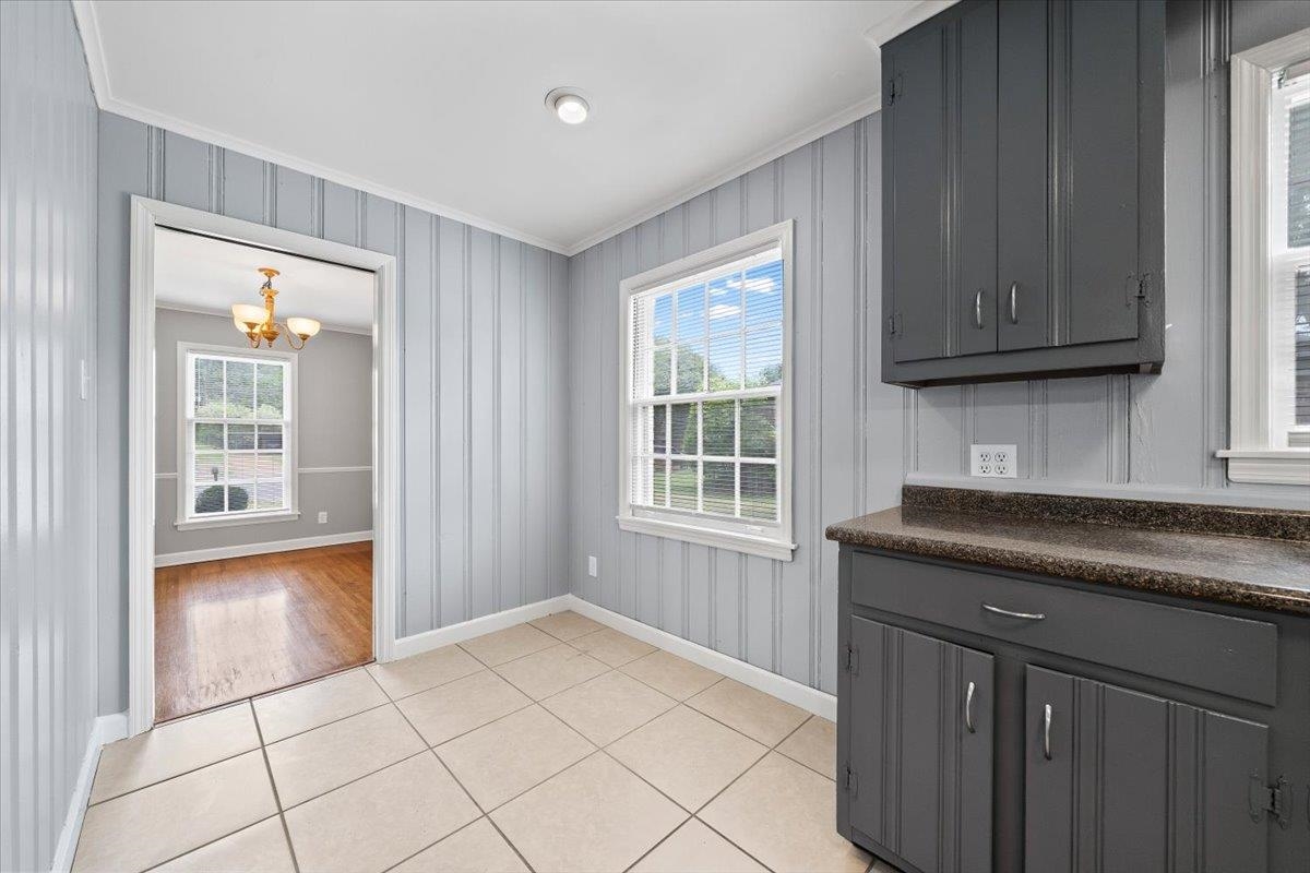 5343 Quince Road Memphis, TN 38119 - Photo 12 of 33 a kitchen with granite countertop a sink cabinets and a window