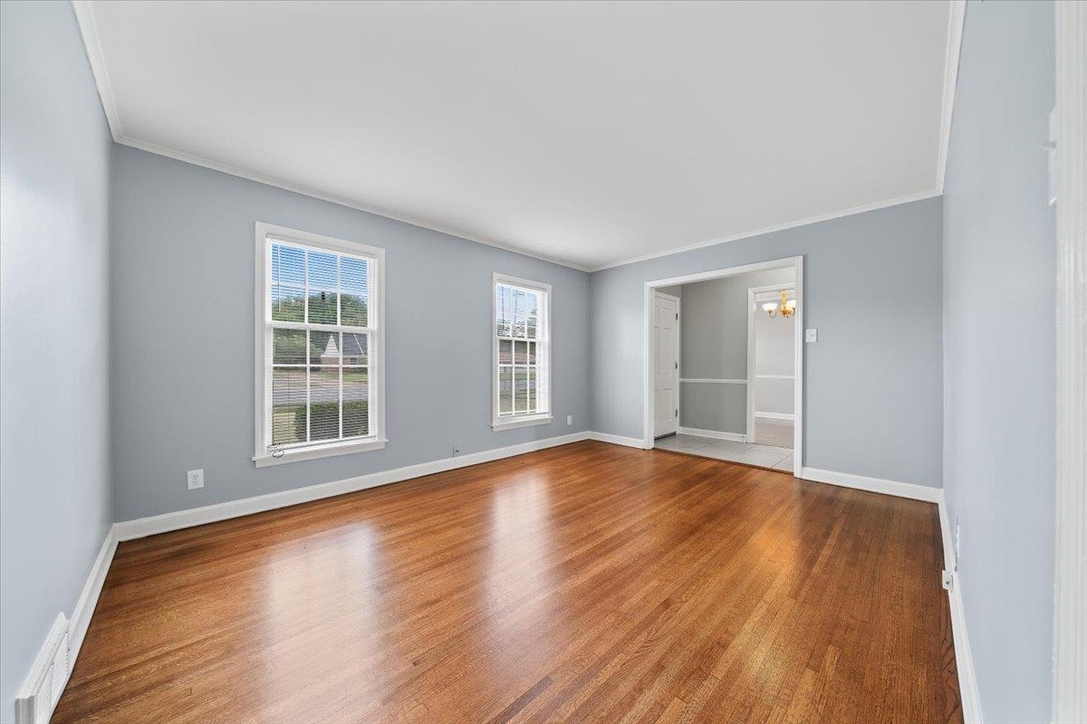 5343 Quince Road Memphis, TN 38119 - Photo 18 of 33 an empty room with wooden floor and windows