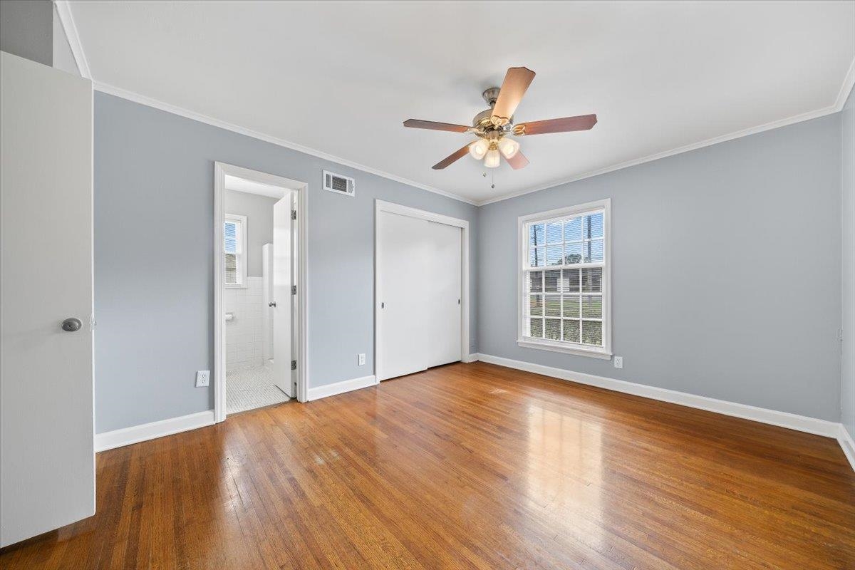 5343 Quince Road Memphis, TN 38119 - Photo 20 of 33 a view of an empty room with wooden floor and a window