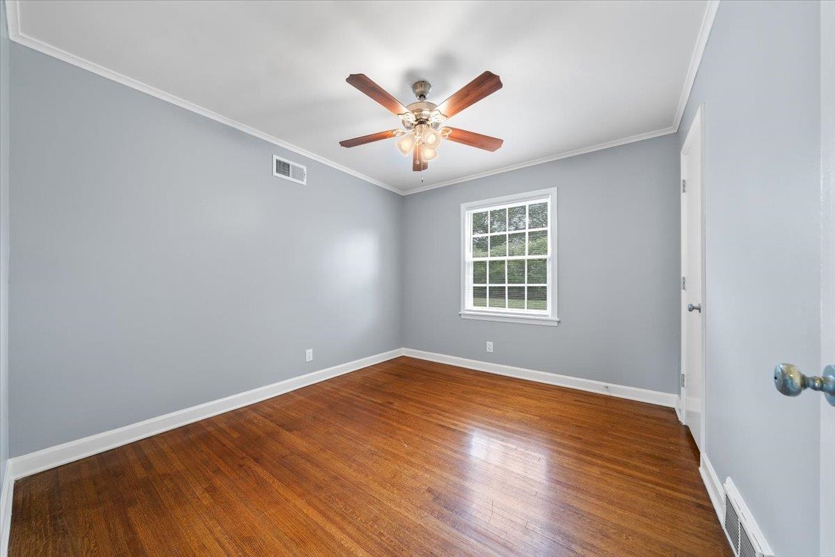 5343 Quince Road Memphis, TN 38119 - Photo 24 of 33 a view of an empty room with window and wooden floor
