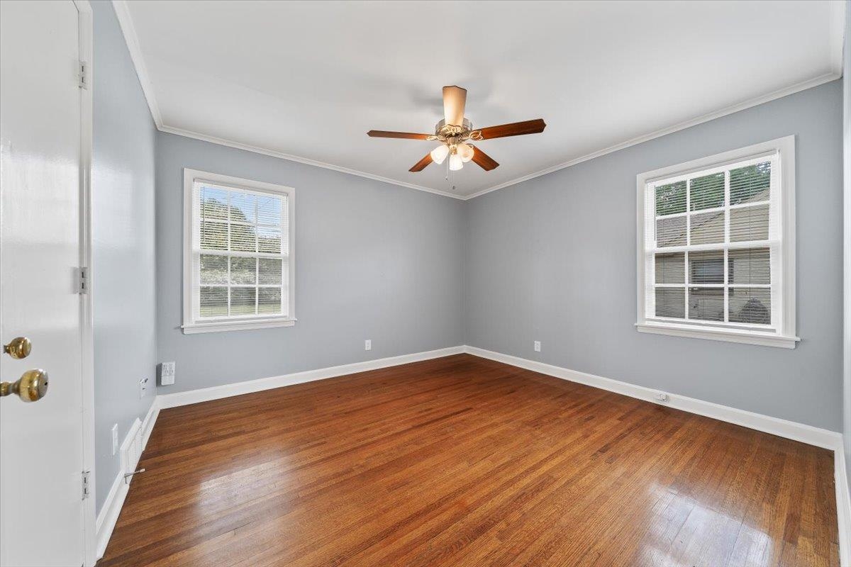 5343 Quince Road Memphis, TN 38119 - Photo 32 of 33 a view of an empty room with a window and wooden floor