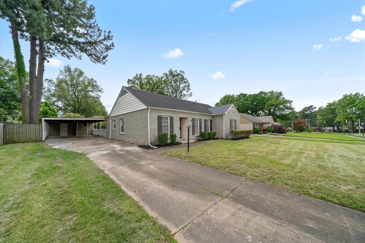 5343 Quince Road Memphis, TN 38119 - Photo 4 of 33 a front view of a house with a garden and yard