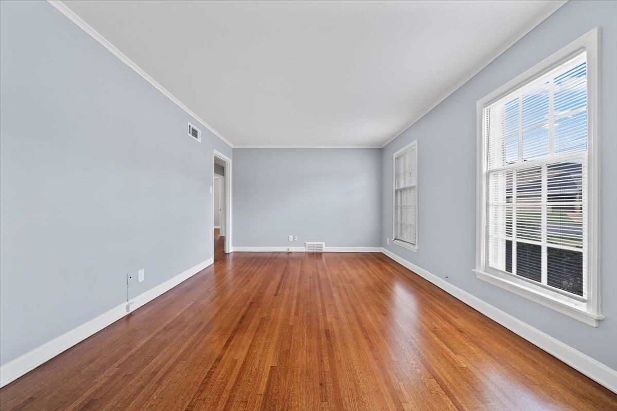 5343 Quince Road Memphis, TN 38119 - Photo 8 of 33 an empty room with wooden floor and windows