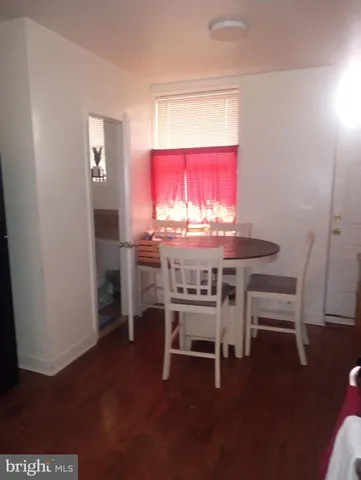 a dining room with furniture and wooden floor