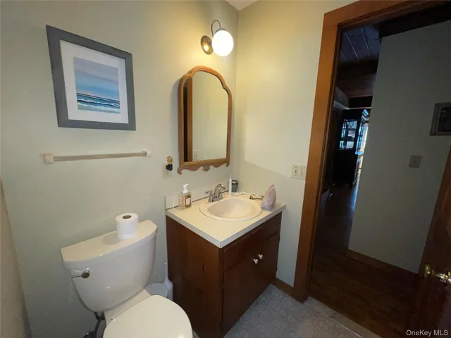 a bathroom with a toilet sink and mirror