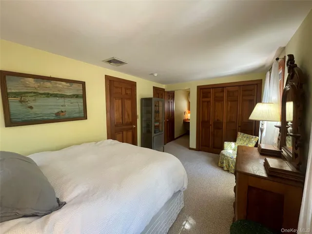 a view of a hallway with a chair and a window