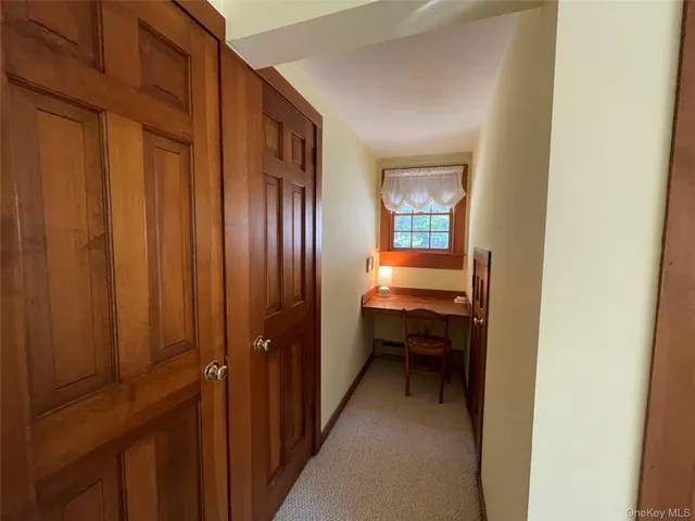a view of a roof deck with couches and wooden floor