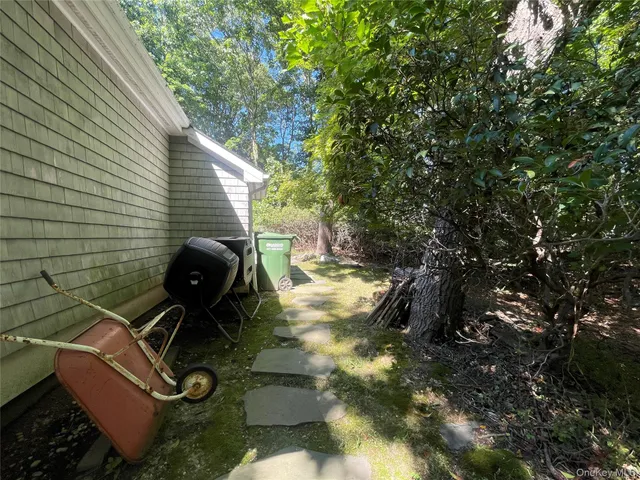 a backyard of a house with plants and trees