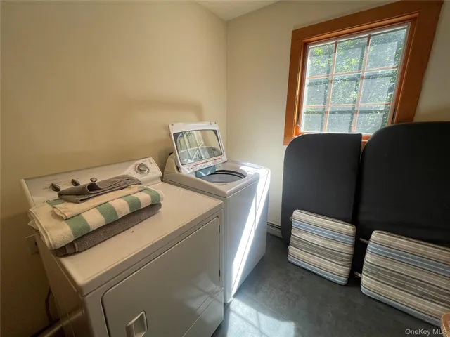 a utility room with furniture and windows