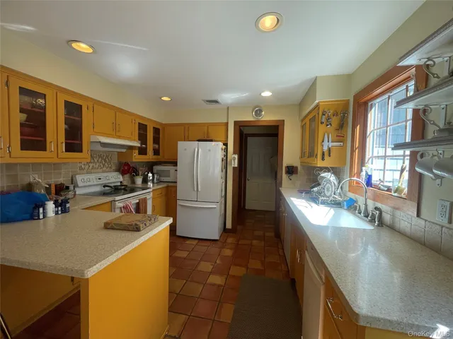 a kitchen with refrigerator and stove