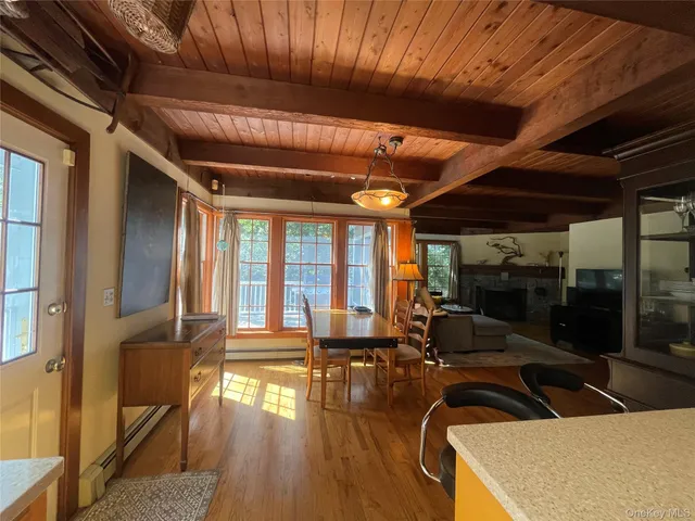 a room with wooden furniture and large windows
