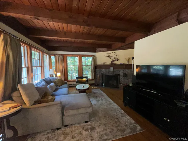 a living room with furniture a fireplace and a flat screen tv