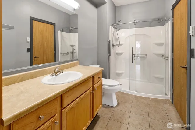 a bathroom with a sink toilet and shower