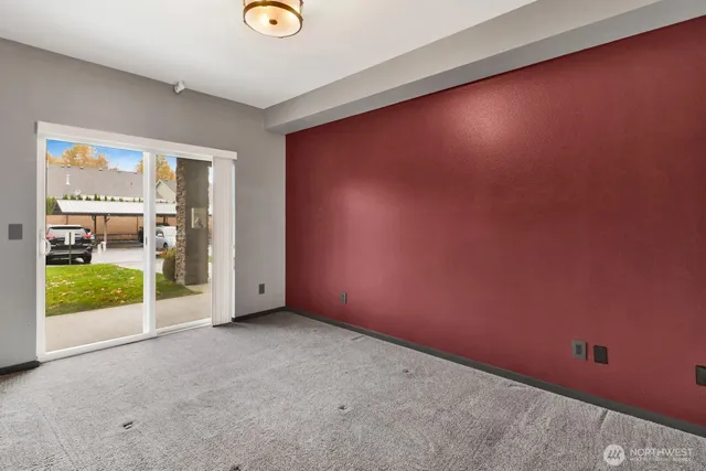 an empty room with floor to ceiling window