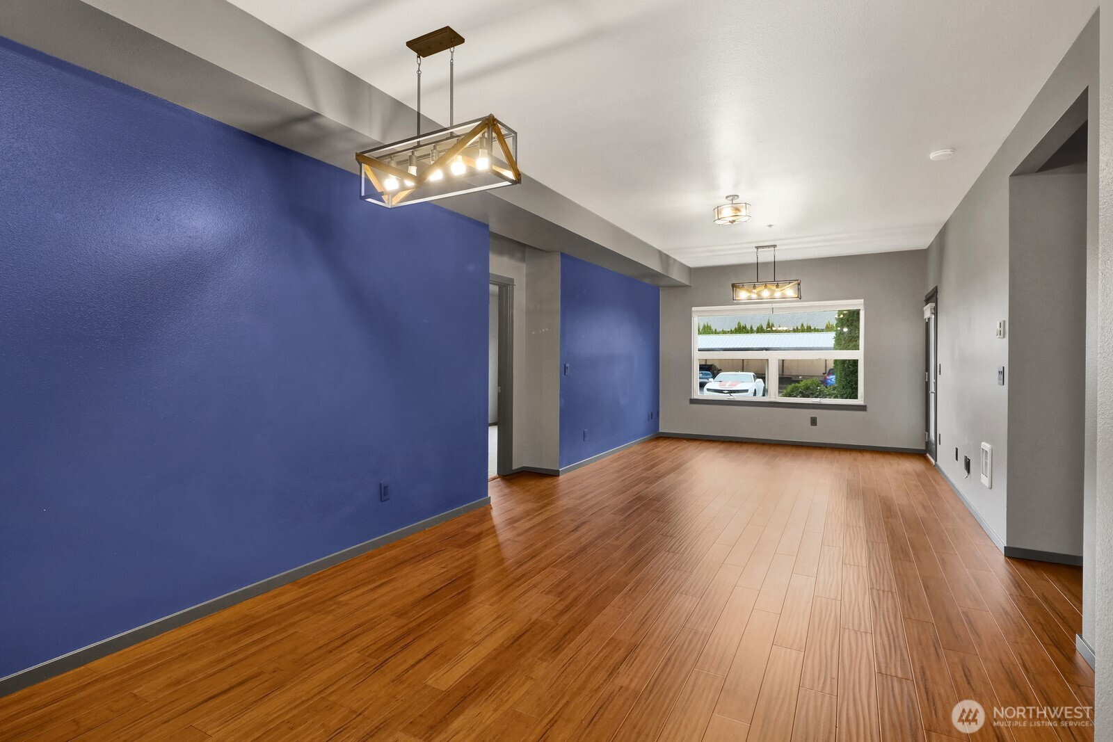 516 Darby Drive, Unit 104 Bellingham, WA 98226 - Photo 20 of 40 an empty room with wooden floor chandelier and windows